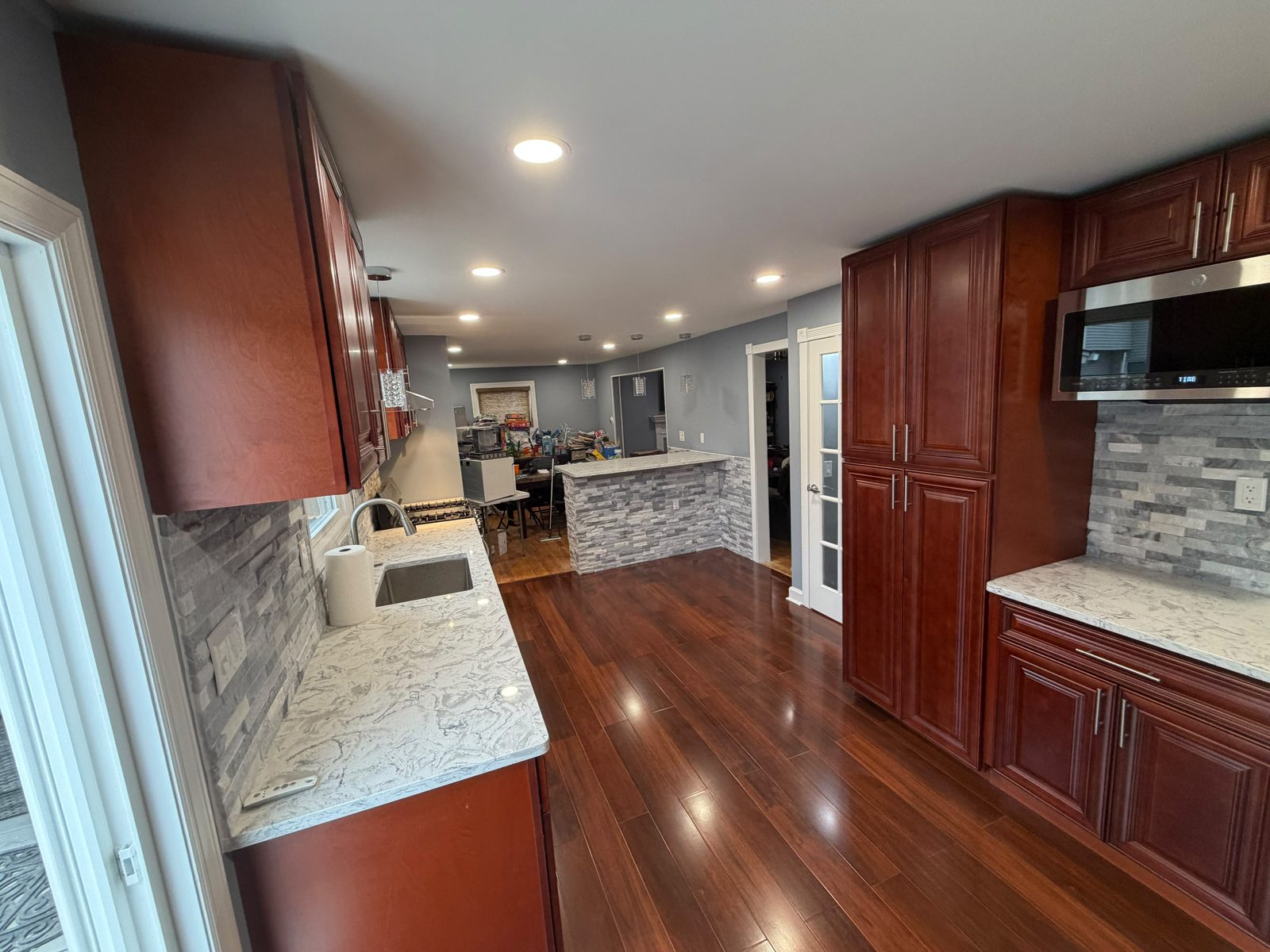 Updated kitchen with custom cabinetry and stone backsplash